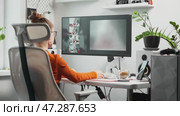 In modern design studio, young woman uses AI tools for creating unique visuals. The AI-powered setup empowers young woman creativity, revolutionizing design with cutting-edge technology. Стоковое видео, видеограф Енваев Андрей / Фотобанк Лори