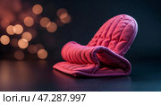 Cozy pink oven mitt placed on a dark surface with soft glowing lights in the background. Стоковое AI-изображение, AI-художник Сергей Толмачёв / Фотобанк Лори