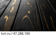 High-quality wooden surface with dark finish and golden streaks in close-up view showcasing texture and pattern details. Высококачественная деревянная поверхность с темной отделкой и золотистыми прожилками при ближайшем рассмотрении демонстрирует текстуру и детали рисунка. Стоковое AI-изображение, AI-художник Katsiaryna Repich / Фотобанк Лори
