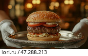 Perfectly crafted gourmet burger served on a silver platter in a cozy restaurant setting. Идеально приготовленный бургер для гурманов подается на серебряном блюде в уютной ресторанной обстановке. Стоковое AI-изображение, AI-художник Katsiaryna Repich / Фотобанк Лори