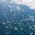 Top view of spring ice drift on Baikal Lake. White pieces of ice floes and needle-like fragments of ice floes float on blue water on spring day. Changing seasons. Natural water background, texture of melting ice. Стоковое фото, фотограф Виктория Катьянова / Фотобанк Лори