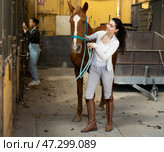 Woman with horse on leash in stable. Стоковое фото, фотограф Яков Филимонов / Фотобанк Лори