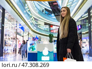 Excitement Fills the Air as a Shopper Navigates a Vibrant Modern Mall. Стоковое фото, фотограф Aleksandr Golubev / Фотобанк Лори