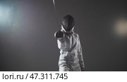 Fencing - a person in a white protective suit directs the sword at the enemy. Стоковое видео, видеограф Константин Шишкин / Фотобанк Лори