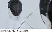 Fencing - two young women fencers in white suits and protective helmets training the fight. Стоковое видео, видеограф Константин Шишкин / Фотобанк Лори