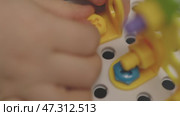 baby child hands screwing nut and screw-bolt plastic game set constructor puzzle. Стоковое видео, видеограф Olesia Kondrateva / Фотобанк Лори
