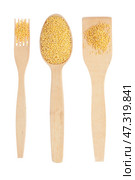 Wooden spoon, fork, paddle with millet. Стоковое фото, фотограф Александр Собко / Фотобанк Лори