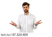 Male wearing light shirt, palms up, puzzled face, standing on plain backdrop, unsure attitude, curious pose, simple setting. Стоковое AI-изображение, AI-художник Павел Муравьев / Фотобанк Лори