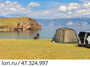 Baikal Lake on summer sunny day. Tourists relax in a tent on the shore of the Small Sea near the village of Kharantsy. Summer travel on Olkhon Island. Outdoor recreation concept. Стоковое фото, фотограф Виктория Катьянова / Фотобанк Лори