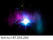 Flying bright sparks from welding on a dark background. Стоковое фото, фотограф Лазаренко Светлана / Фотобанк Лори