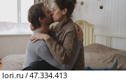 Mature couple hugging hugging each other kissing at home bedroom. Intimate Moment. Tender embrace shared between a loving middle age man and woman, husband and wife. Deep love. Low key, cinematic. Стоковое видео, видеограф Марина Демидюк / Фотобанк Лори