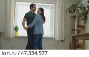 Emotional Dance. Middle-aged Couple Dancing Together Embrace at Home. Mature Couple dancing bonding, smiling and moving to the rhythm in a romantic vibe enjoying their anniversary. Active relationship. Стоковое видео, видеограф Марина Демидюк / Фотобанк Лори
