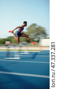 Man is jumping over a hurdle on a track. Стоковое AI-изображение, AI-художник Sergey Grishin / Фотобанк Лори