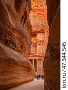 Petra, Wadi Musa, Jordan - Mar 06 2023, view of Al-Khazneh tomb from Siq Gorge, symbol of the city of Petra, Wadi Musa, Jordan. Редакционное фото, фотограф Сергей Богомяко / Фотобанк Лори