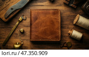 Craftsmanship of leather wallet displayed on a wooden workbench with tools. Мастерство изготовления кожаного кошелька демонстрируется на деревянном верстаке с инструментами. Стоковое AI-изображение, AI-художник Katsiaryna Repich / Фотобанк Лори