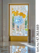 Abu Dhabi, United Arab Emirates - Jan 10 2024, A view of door with stained glass window with a floral pattern, in the Grand Mosque of Sheikh Zayed, at daytime Abu Dhabi, United Arab Emirates. Редакционное фото, фотограф Сергей Богомяко / Фотобанк Лори