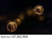 Abu Dhabi, United Arab Emirates - Jan 17 2024, Close-up view of the ancient antique coins in the Louvre Abu Dhabi Museum, belonging to different eras, Abu Dhabi, United Arab Emirates. Редакционное фото, фотограф Сергей Богомяко / Фотобанк Лори