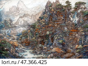A fantastic mountain landscape reminiscent of ancient oriental scrolls. Along the slopes of high cliffs there is an entire city, organically integrated into nature. Multi-level pagodas and temples with curved roofs cling to stone ledges, surrounded by centuries-old trees, waterfalls and streams. Between the buildings there are bridges, paths, stairs, as if carved out of the rocks. In the background there are majestic peaks drowning in clouds. Water flows everywhere: winding rivers, lakes, cascades. The atmosphere is peaceful, fabulous, as if this is a place hidden from the world, where sages, artists or mountain spirits live. Стоковое AI-изображение, AI-художник Анна Кривицкая / Фотобанк Лори