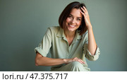 Joyful Woman Shares a Radiant Smile in Soft Natural Light, Showcasing Effortless Elegance and Warmth in Her Expression. Стоковое AI-изображение, AI-художник Sergey Grishin / Фотобанк Лори