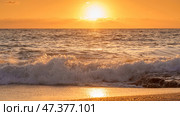 Alanya, Antalya, Türkiye, Turkey, Panoramic view of the undulating Mediterranean Sea with waves at sunset, bright orange sun in the sky and clouds around (2022 год). Стоковое фото, фотограф Сергей Богомяко / Фотобанк Лори