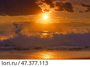 Alanya, Antalya, Türkiye, Turkey, Panoramic view of the undulating Mediterranean Sea with waves at sunset, bright orange sun in the sky and clouds around (2023 год). Стоковое фото, фотограф Сергей Богомяко / Фотобанк Лори