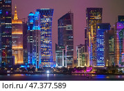 Doha, Qatar - Jan 07 2024, Panorama of the skyscrapers of Doha downtown business centers, with illumination and street lights on, at nighttime Doha, Qatar. Редакционное фото, фотограф Сергей Богомяко / Фотобанк Лори