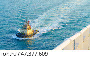 Manama, Bahrain - Jan 08 2024, Aerial view of tugboat, boat, what passing by, with blue sea, at daytime, Manama, Bahrain. Редакционное фото, фотограф Сергей Богомяко / Фотобанк Лори