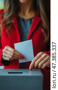 Woman Casting Her Ballot in a Voting Booth During an Election in a Busy Urban Area. Стоковое AI-изображение, AI-художник Юлия Гапеенко / Фотобанк Лори