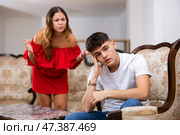 Unhappy woman quarrelling with husband at home interior. Стоковое фото, фотограф Яков Филимонов / Фотобанк Лори