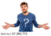 Young bearded man with puzzled face raising hands in questioning gesture, wearing blue shirt with big question mark, expressing confusion, isolated on white, doubtful, searching for answers. Стоковое AI-изображение, AI-художник Павел Муравьев / Фотобанк Лори