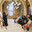 Manama, Bahrain - Jan 15 2024, An Arab woman dressed in a black burqa and niqab enthusiastically tells group of tourists about history of Islam inside of the Grand Mosque Al Fateh, Manama, Bahrain. Редакционное фото, фотограф Сергей Богомяко / Фотобанк Лори