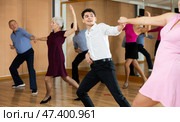 Confident young male dancer practicing ballroom dances in ballroom. Стоковое фото, фотограф Яков Филимонов / Фотобанк Лори