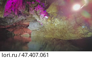 Boating on underground river in dark cave. Стоковое видео, видеограф Михаил Коханчиков / Фотобанк Лори