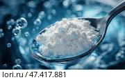Close-up view of protein powder on a spoon submerged in water. Ложка порошка сыпучего протеина частично погружена в прозрачную воду, создавая динамичный визуальный контраст с пузырьками на заднем плане, подчеркивая важность питания и добавок. Стоковое AI-изображение, AI-художник Katsiaryna Repich / Фотобанк Лори