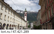 Улица города Инсбрук с видом на церковь и горы. Австрия. Май. Street of the city of Innsbruck with a view of the church and mountains. Austria. May. Редакционное видео, видеограф Горшков Александр / Фотобанк Лори