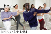 Cheerful african american man enjoying active dancing in studio. Стоковое фото, фотограф Яков Филимонов / Фотобанк Лори