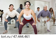 Smiling young woman rehearsing modern dance with group in dance school. Стоковое фото, фотограф Яков Филимонов / Фотобанк Лори