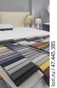 Colorful fabric samples on a bed in a bedroom. Close-up of a palette of textile abstract stripes of different colors. Selective focus. Стоковое видео, видеограф Дмитрий Нечаев / Фотобанк Лори