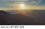 Flying over colorful foliage at sunset in mountains. Стоковое видео, видеограф Михаил Коханчиков / Фотобанк Лори
