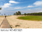 BAIKAL LAKE, OLKHON ISLAND, KHUZHIR VILLAGE, IRKUTSK REGION, RUSSIA - August 03, 2024: Beautiful landscape of Saraiskiy beach and wooden ecological trail along the coast popular with tourists. Редакционное фото, фотограф Виктория Катьянова / Фотобанк Лори