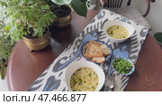 A luxurious creamy mushroom soup garnished with truffle oil  served in a white porcelain bowl. Стоковое видео, видеограф Zita Khasanova / Фотобанк Лори