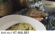 A luxurious creamy mushroom soup garnished with truffle oil  served in a white porcelain bowl. Стоковое видео, видеограф Zita Khasanova / Фотобанк Лори