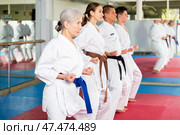 Karate or taekwondo training - athletes in kimono stand in fighting stance. Стоковое фото, фотограф Яков Филимонов / Фотобанк Лори