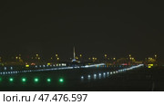 Passenger jet descending toward illuminated runway at night, revealing sequential landing approach from frontal and lower angles. Стоковое видео, видеограф Данил Руденко / Фотобанк Лори