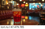 Aromatic aperitivo refreshment: Chilled bittersweet beverage with straw, perfect for happy hour in a cozy dimly-lit establishment. Стоковое AI-изображение, AI-художник Данила Большаков / Фотобанк Лори