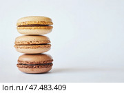 Stack of three brown French Macarons, cakes with coffee and creme brulee flavor. Стоковое фото, фотограф Екатерина Якименко / Фотобанк Лори