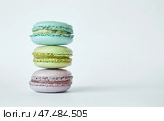 Stack of three colorful French Macarons, macaroons cakes with different flavors. Стоковое фото, фотограф Екатерина Якименко / Фотобанк Лори