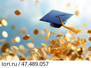 A graduate's cap is joyfully tossed into the air, symbolizing the culmination of academic achievements. The scene is enriched with golden coins, representing the journey towards prosperity and financial freedom. Стоковое AI-изображение, AI-художник Nart / Фотобанк Лори