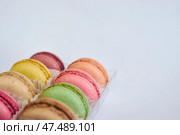 Delicate colorful cakes French Macarons with white paperpan in plastic box. Стоковое фото, фотограф Екатерина Якименко / Фотобанк Лори
