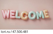 Colorful welcome sign with playful letters against a soft background inviting people to enter a space. Стоковое AI-видео, аниматор Ekaterina Ismagilova / Фотобанк Лори